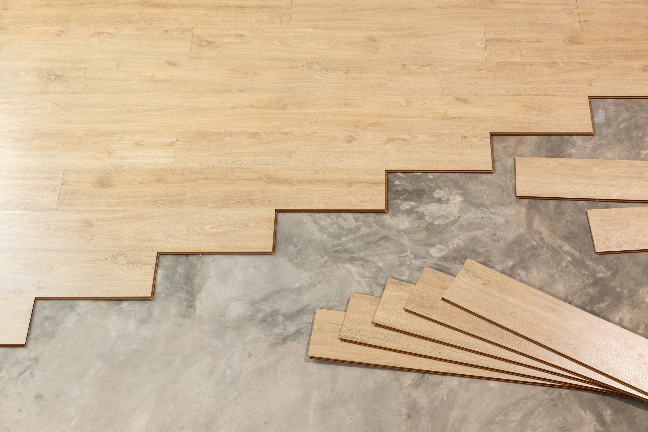 Worker Installing Interlocking laminate floor, home renovation.